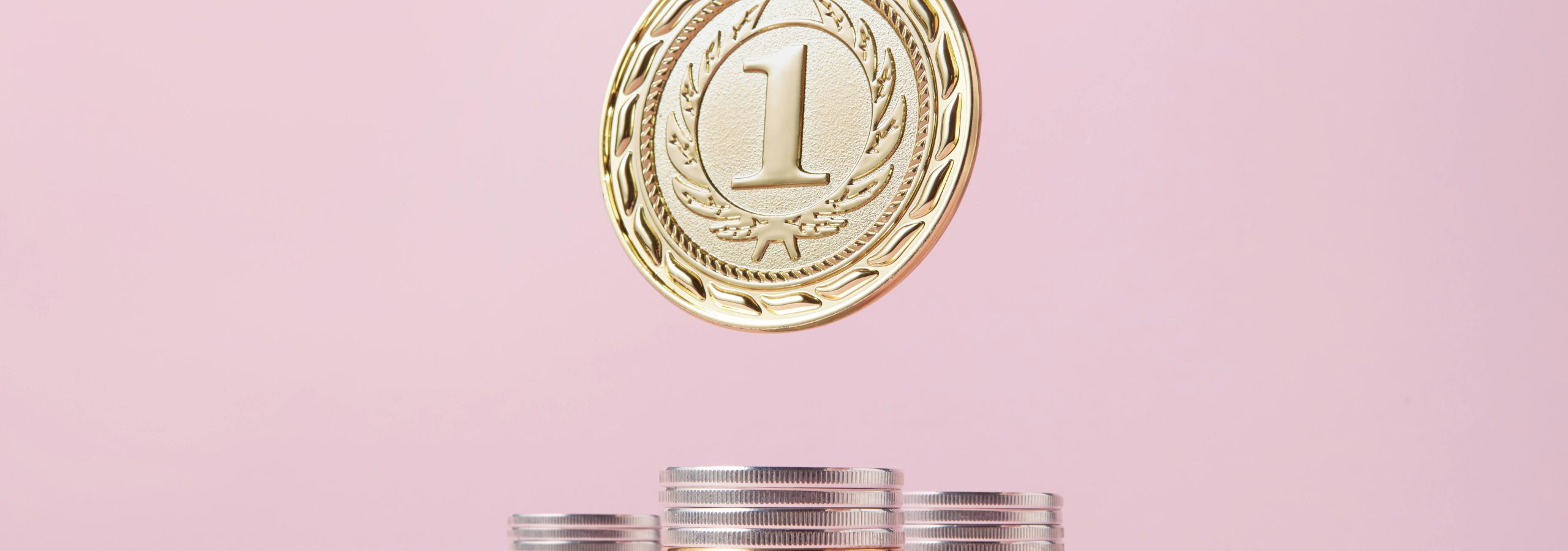 Gold medal hovers over stacks of coins
